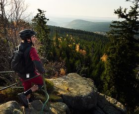 mountainbiker blickt von der ahrensklint klippe hinab nach schierke